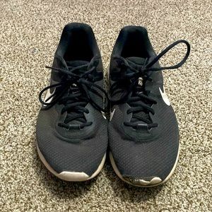 Nike black and white running shoes. Worn, roughed up a little in the front.